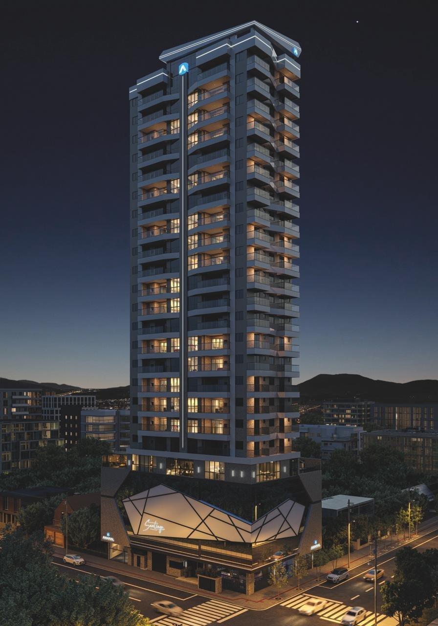 Fachada do Santiago Residencial ao entardecer, com entrada em vidro facetado iluminada